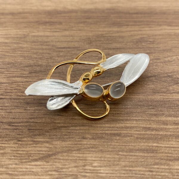 Gold and silver dragonfly brooch with stones.