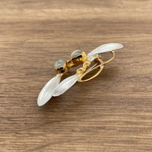 Gold and silver dragonfly brooch with stones.