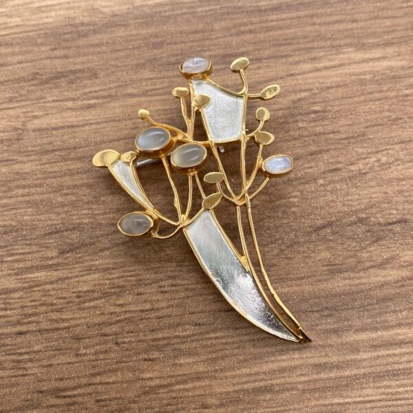 Gold and silver brooch with moonstone gems.