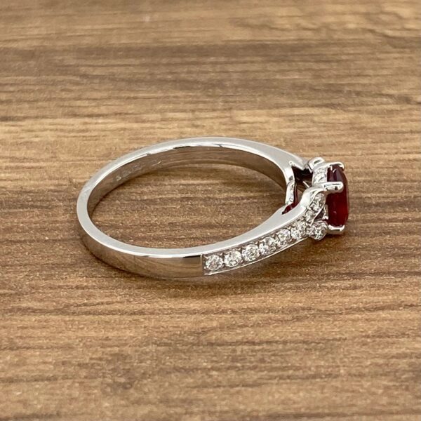 Diamond ring with a ruby gemstone.