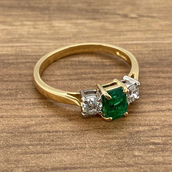 Gold ring with emerald and diamonds.