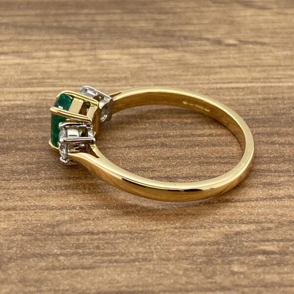 Gold ring with emerald and diamonds.