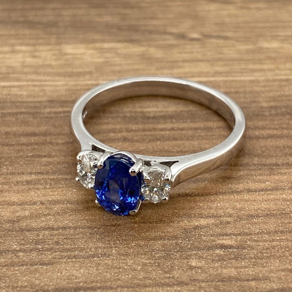 White gold ring with blue sapphire and diamonds.