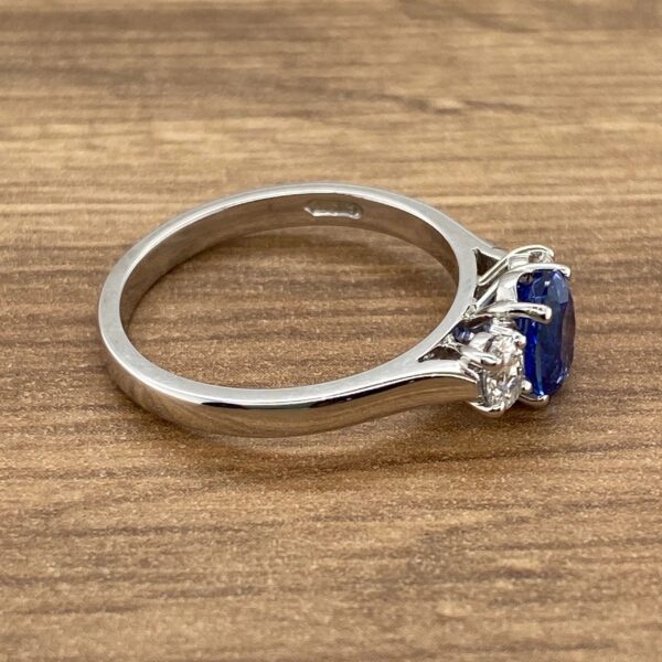 Silver ring with blue sapphire and diamonds.