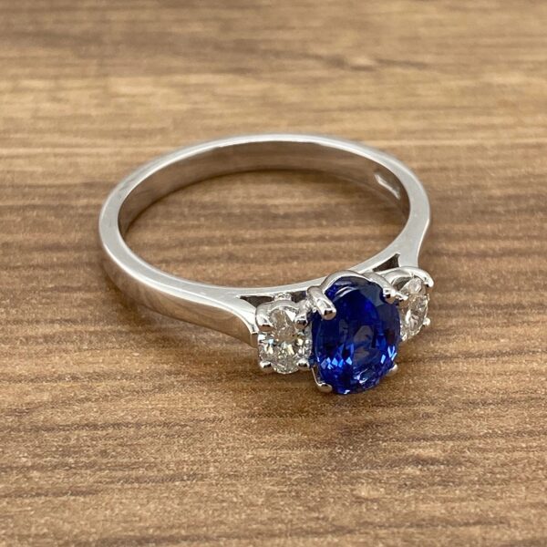 White gold ring with blue sapphire and diamonds.