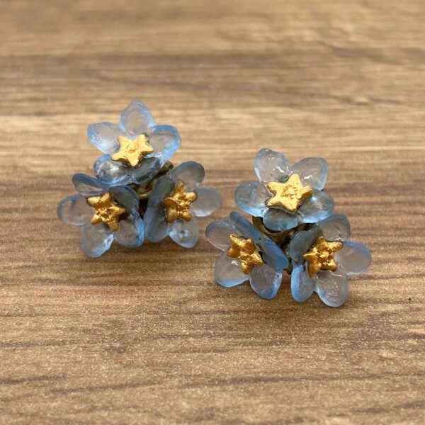 Blue flower earrings with gold centers.