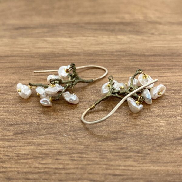 Silver earrings with pearl clusters.