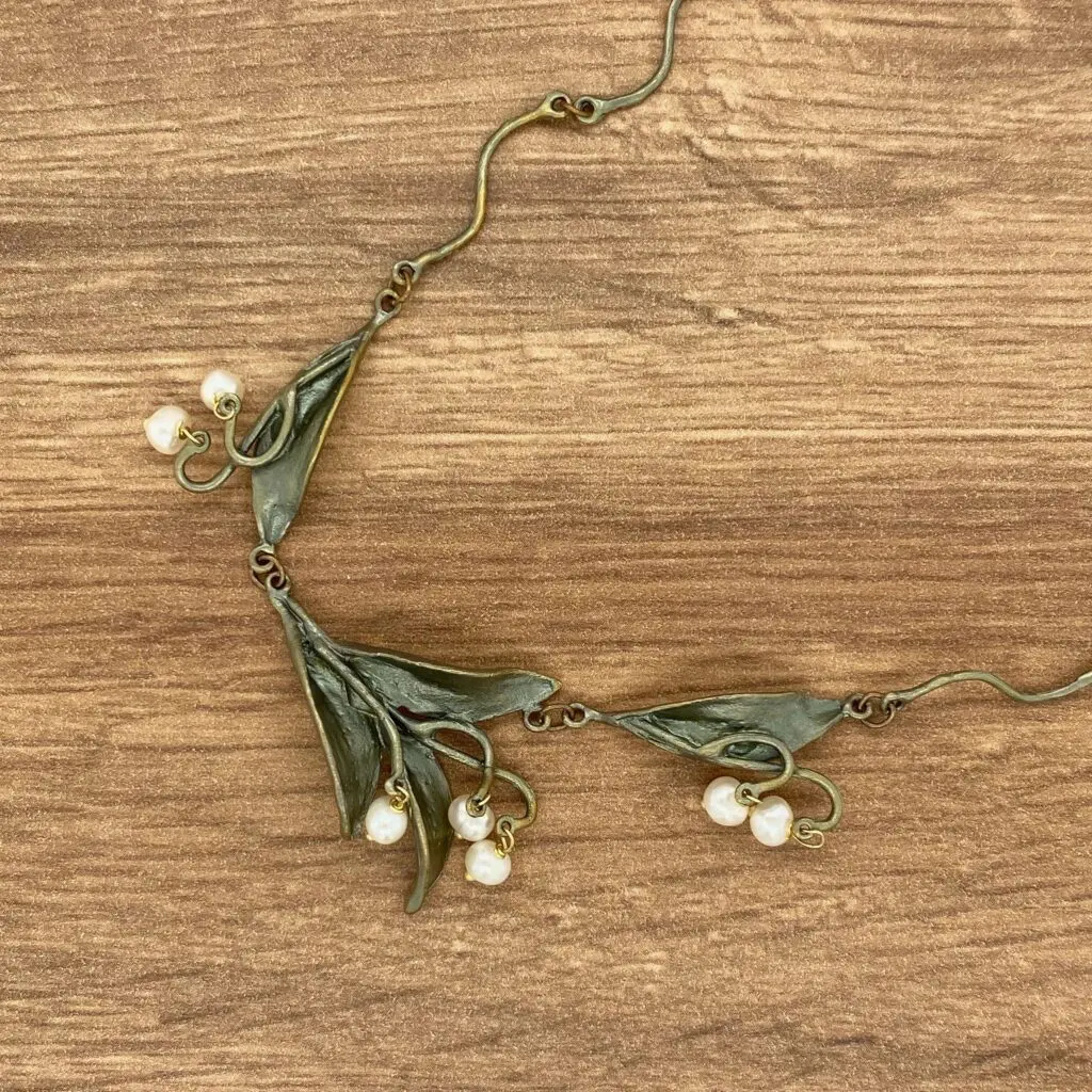 Bronze leaf necklace with pearl accents.