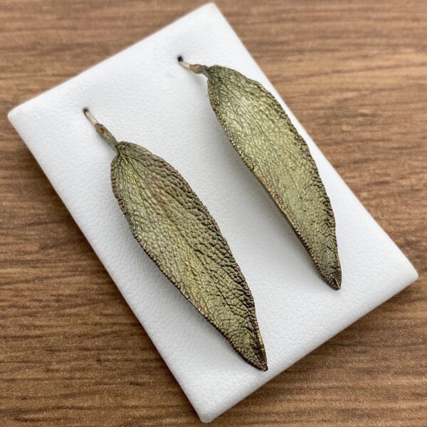 Two green leaf-shaped earrings.