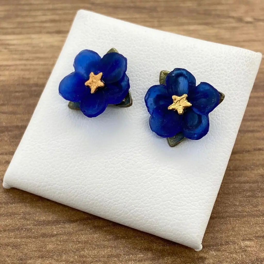 Pair of blue flower stud earrings.