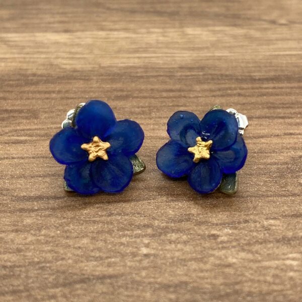 Blue flower stud earrings with gold center.