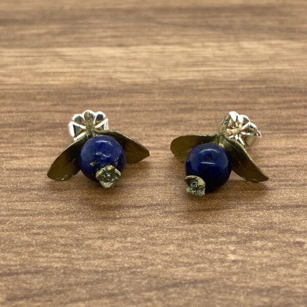 Blue gemstone earrings with gold leaf design.