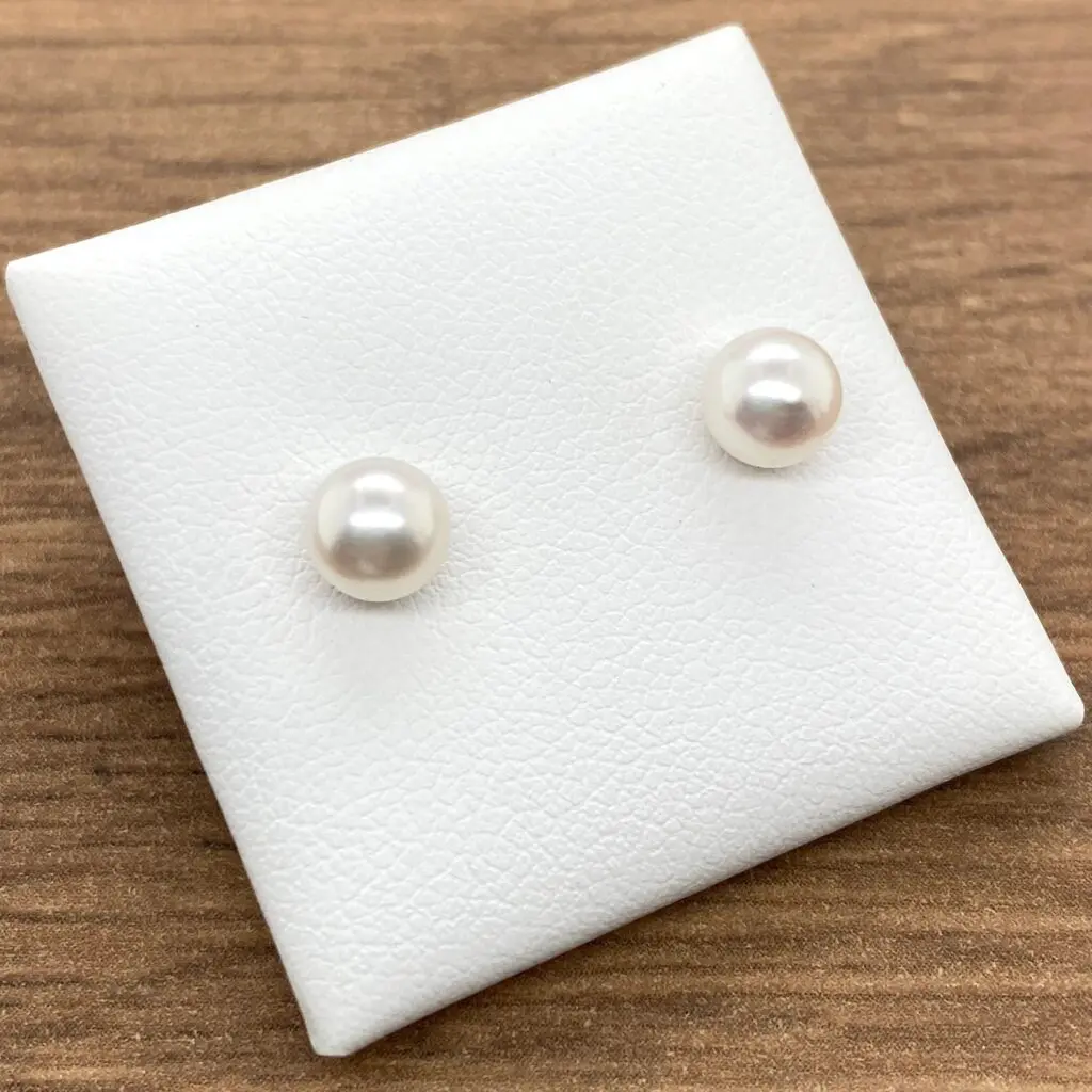 Pair of white pearl stud earrings.