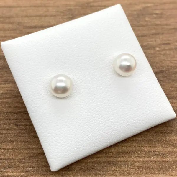 Pair of white pearl stud earrings.