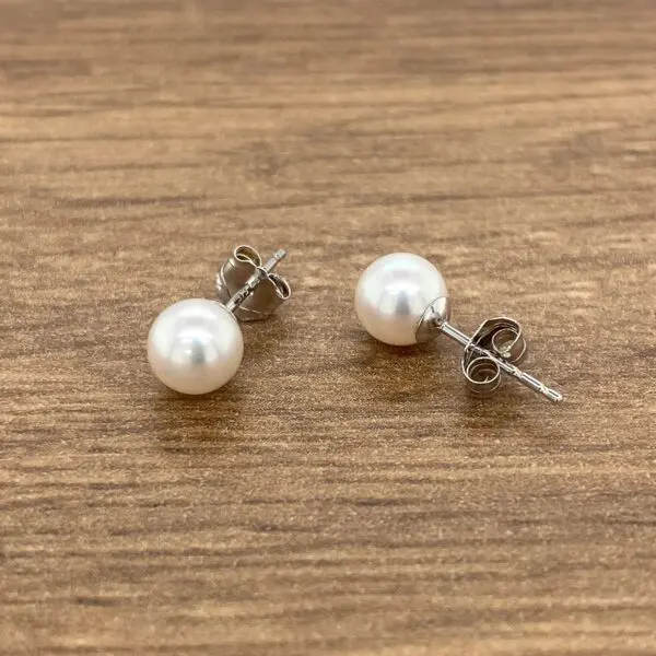 Pair of white pearl stud earrings.