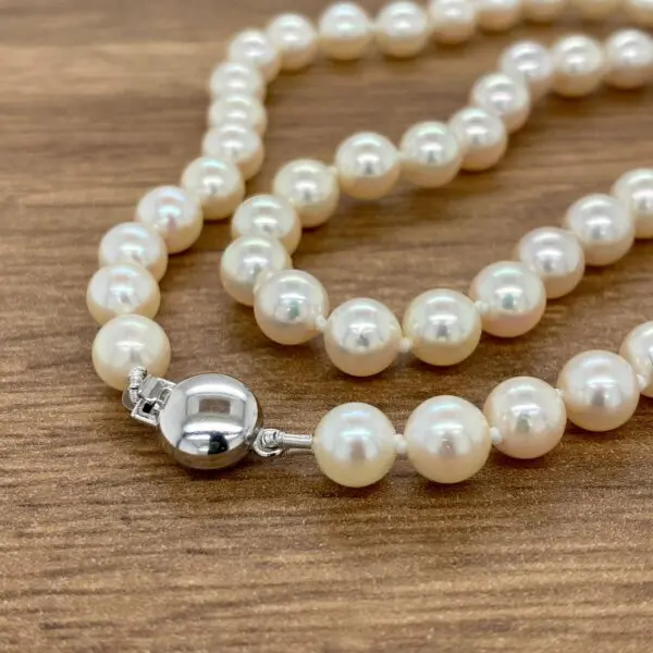 White pearl necklace with silver clasp.