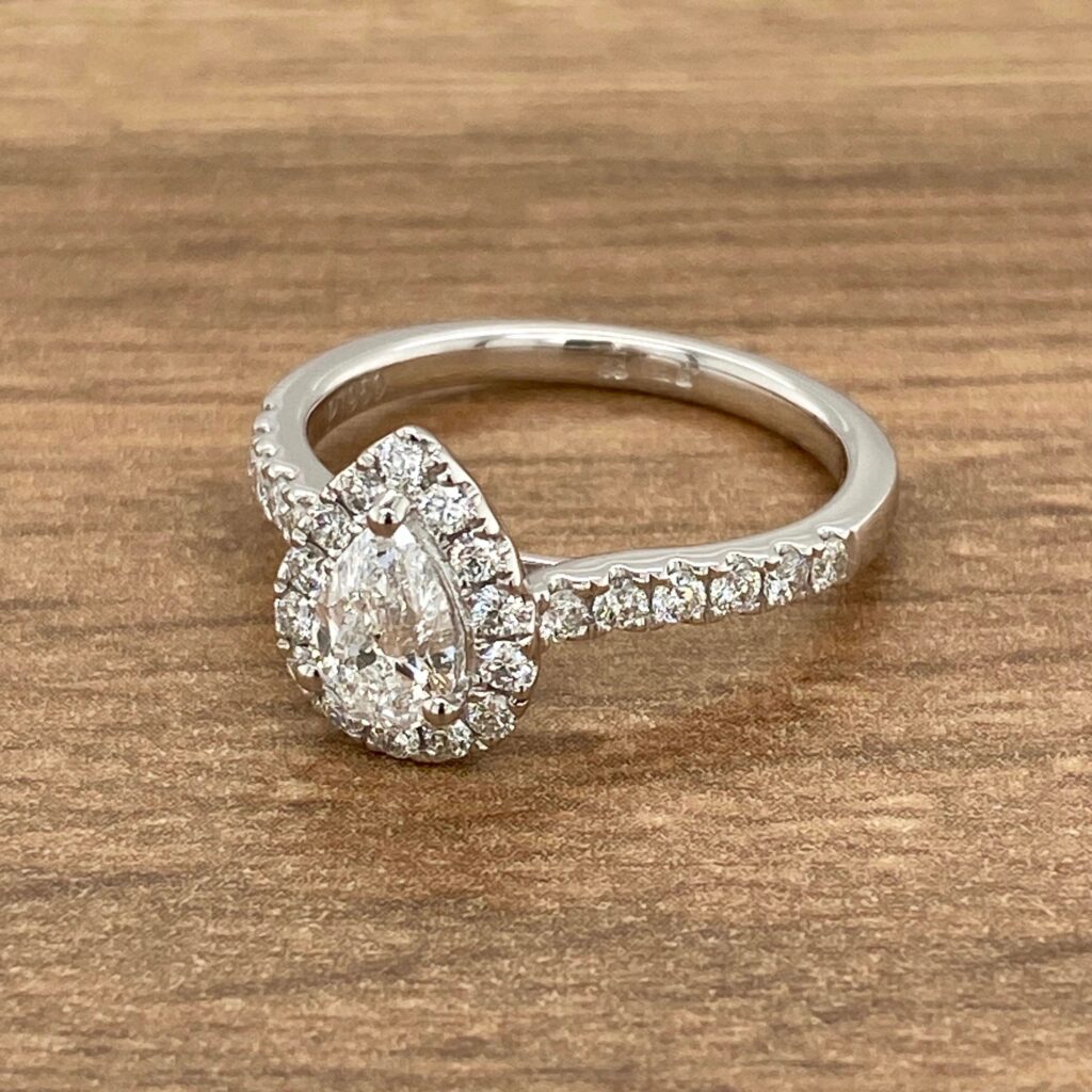 Pear-shaped diamond engagement ring with halo setting.