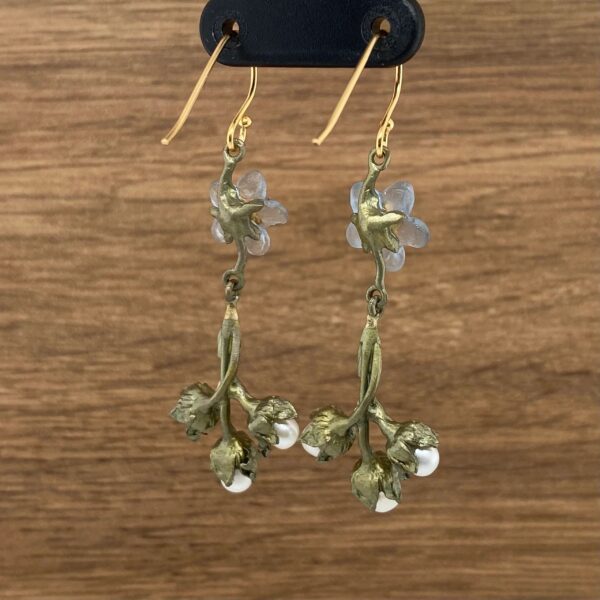 Gold floral earrings with pearl accents.