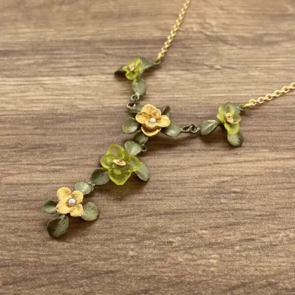 Gold and green floral necklace with pearls.