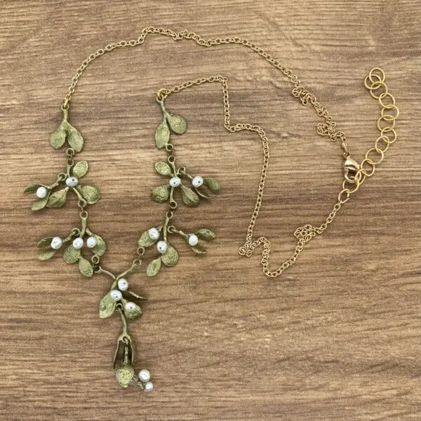 Gold mistletoe necklace with white pearls.