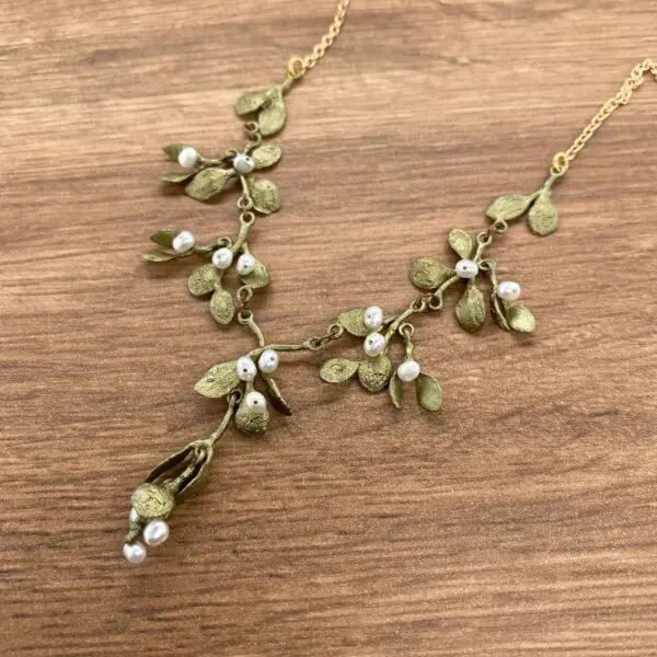 Gold mistletoe necklace with pearls.