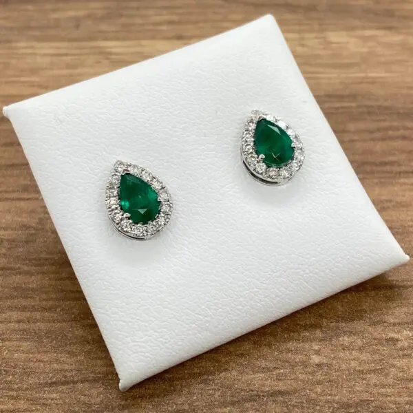 Emerald and diamond pear-shaped earrings.