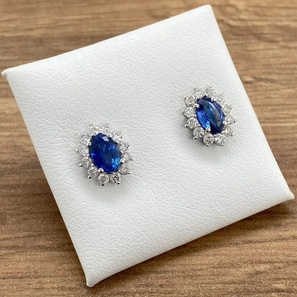 Pair of oval sapphire and diamond earrings.