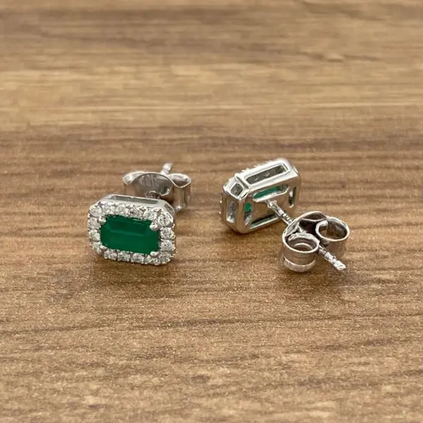 Emerald and diamond stud earrings.