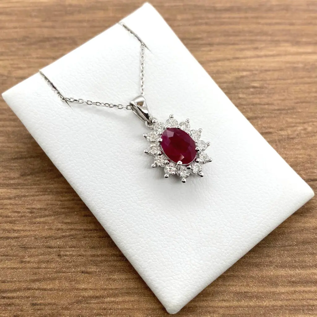 Oval ruby and diamond pendant necklace.