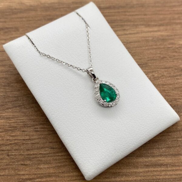 Emerald and diamond pear-shaped pendant necklace.