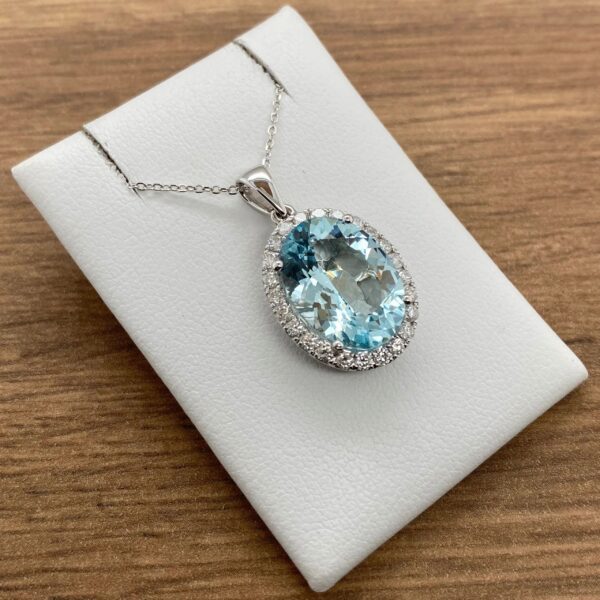 Aquamarine pendant necklace with diamond halo.