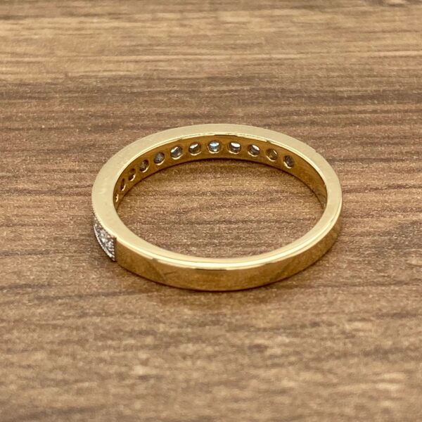 Gold band with diamond accents.