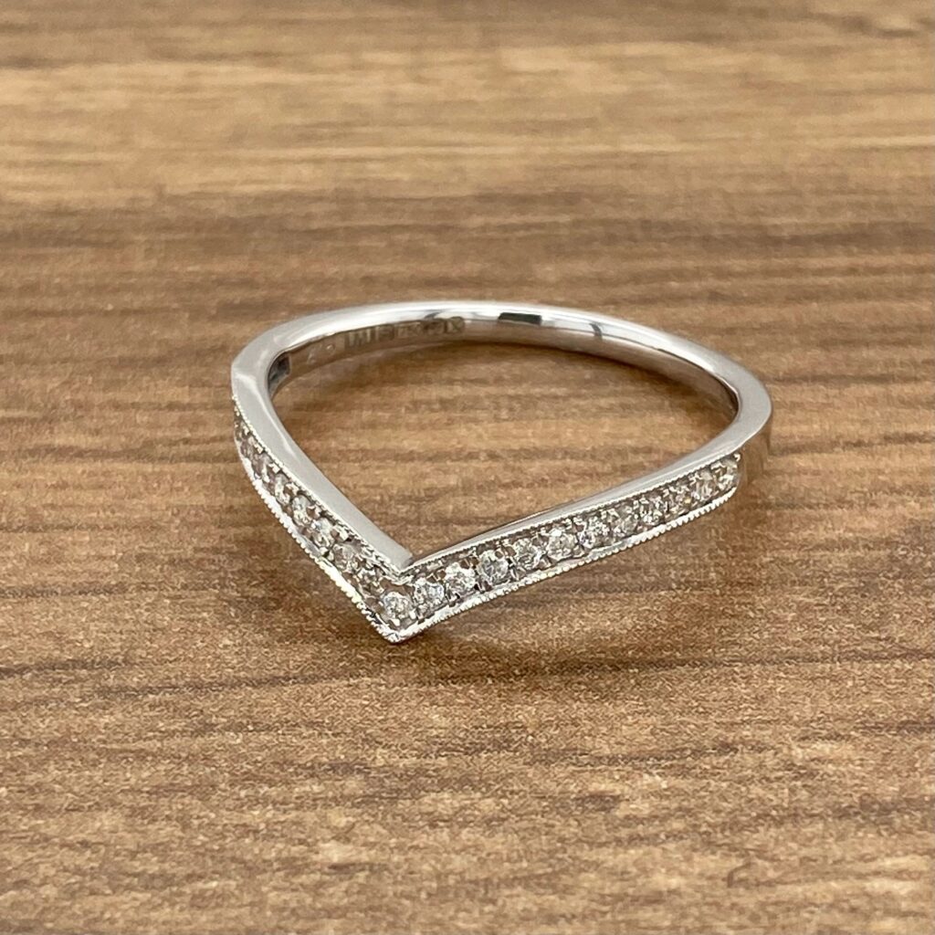 Diamond V-shaped wedding band ring.