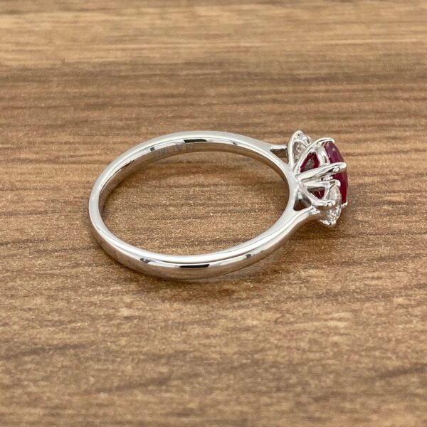 Silver ring with ruby and diamond accents.