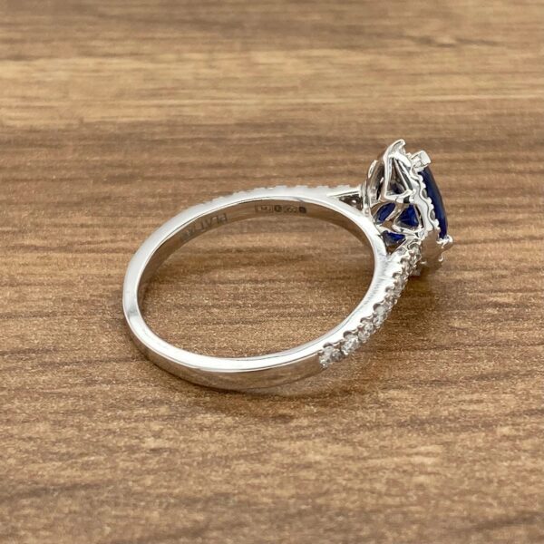 A silver ring with a blue sapphire stone.