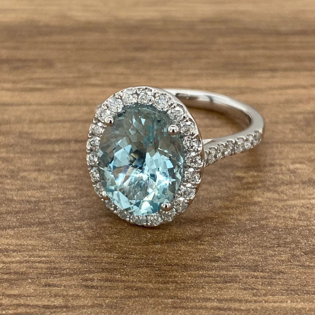 Aquamarine engagement ring with diamond halo.