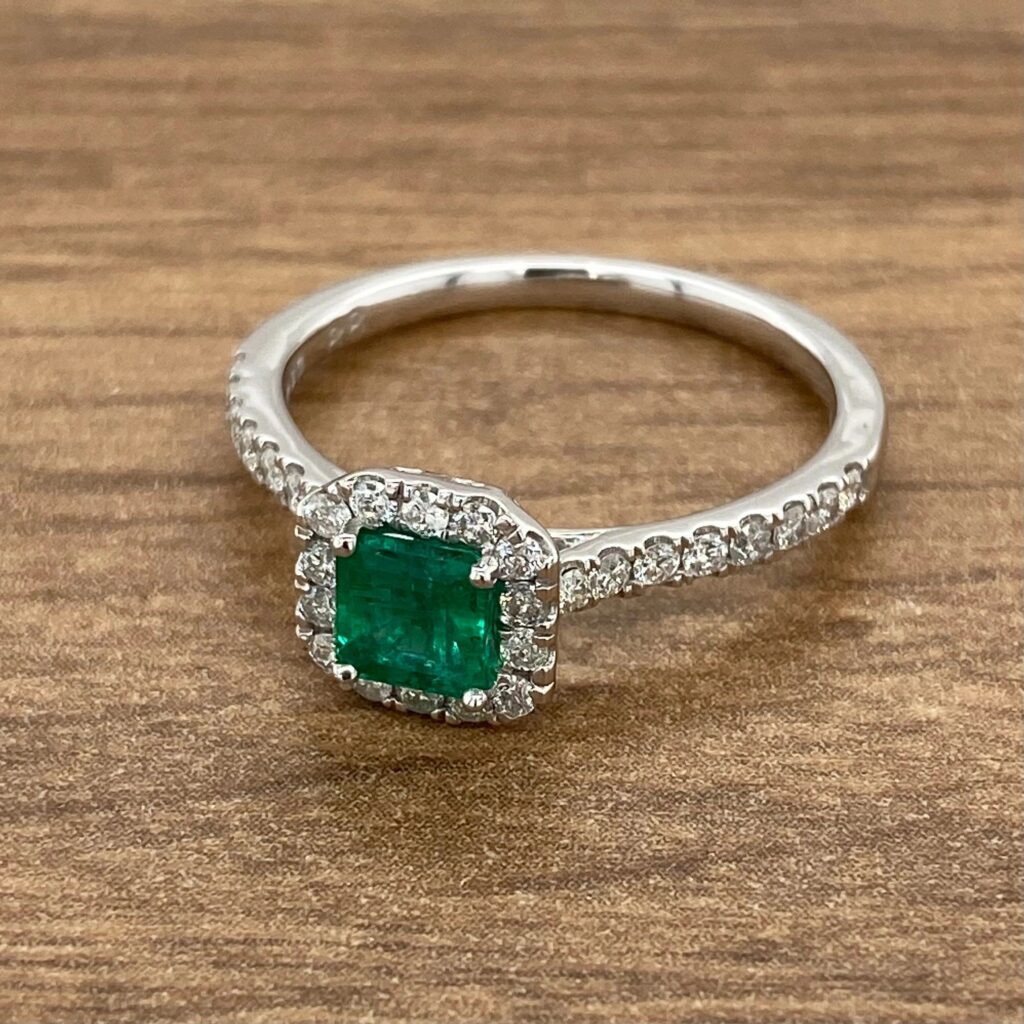 Emerald and diamond halo engagement ring.