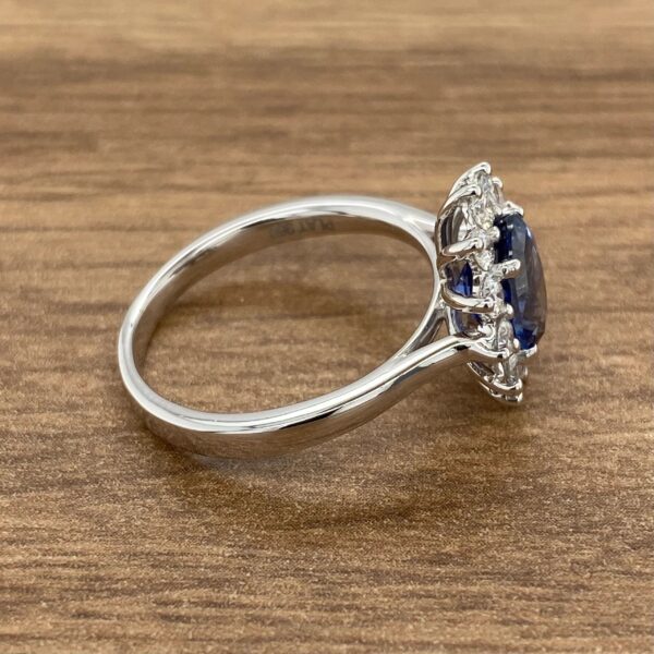 Silver ring with a blue sapphire and diamonds.