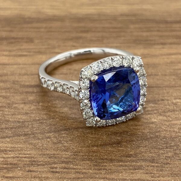 Diamond halo ring with blue sapphire center stone.