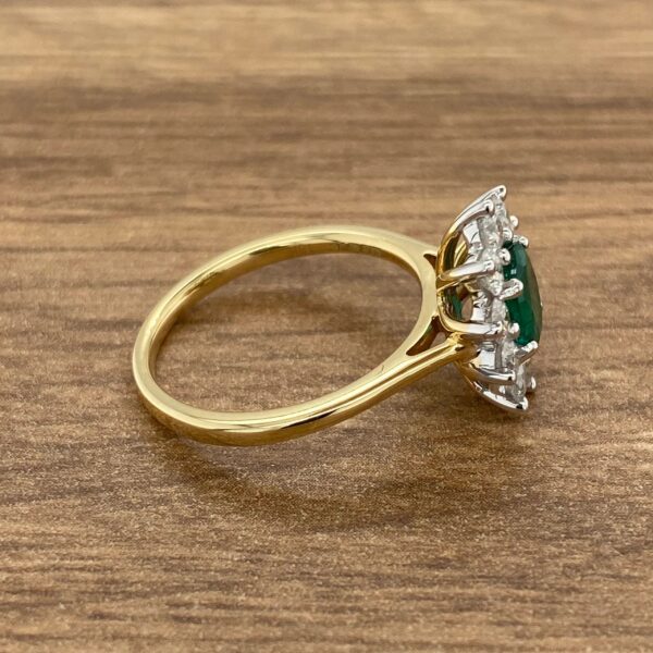 Gold ring with emerald and diamond stones.