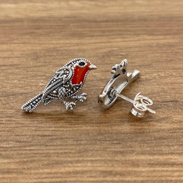 Silver earrings with red robin design.