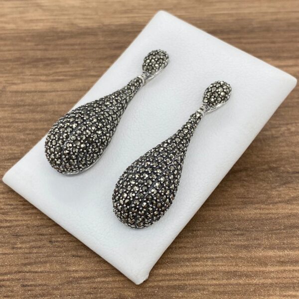 Silver teardrop earrings with marcasite stones.