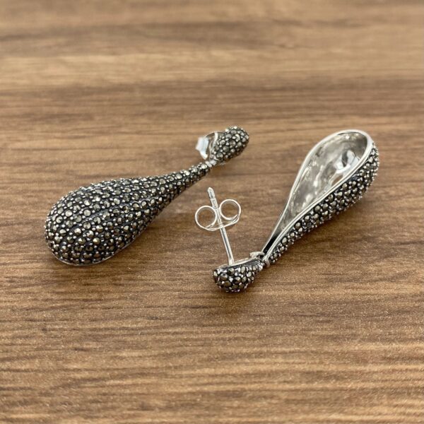 Silver teardrop earrings with marcasite stones.