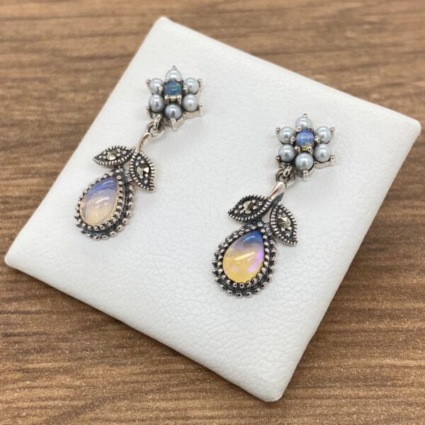 Silver earrings with opal and pearl flowers.