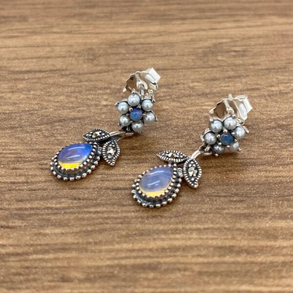 Silver earrings with opal stones and pearls.