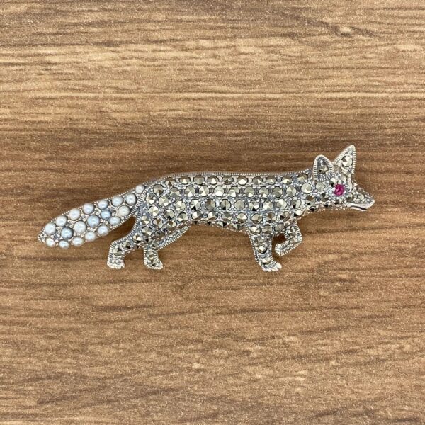 Silver fox brooch with pearl tail.