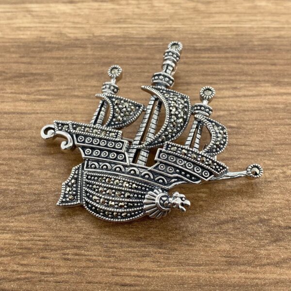 Silver ship brooch with marcasite stones.