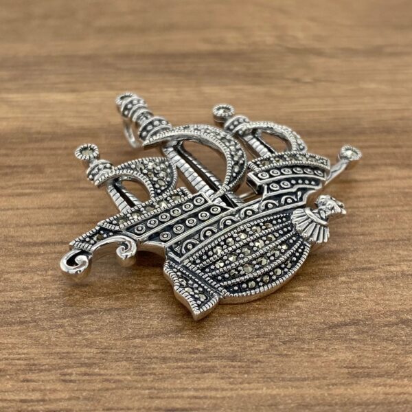 Silver ship brooch with marcasite stones.