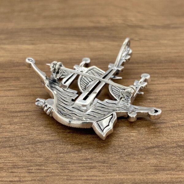 Silver ship brooch with pin on back.