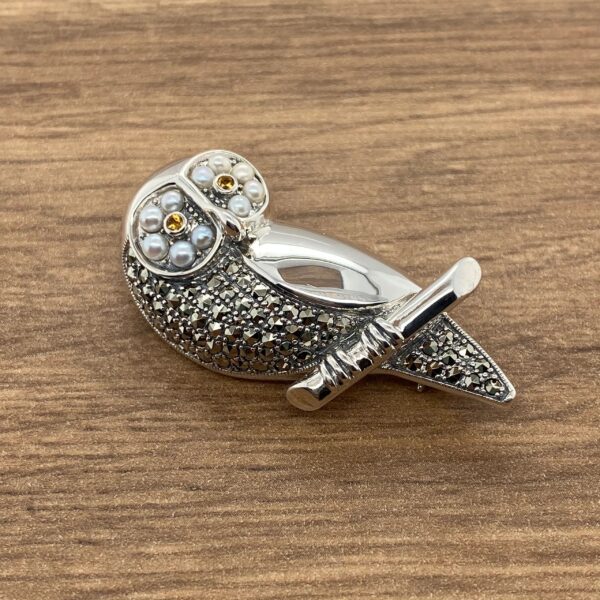 Silver owl brooch with pearl eyes.